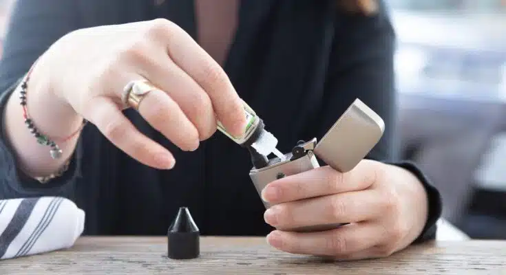 person holding silver flip lighter